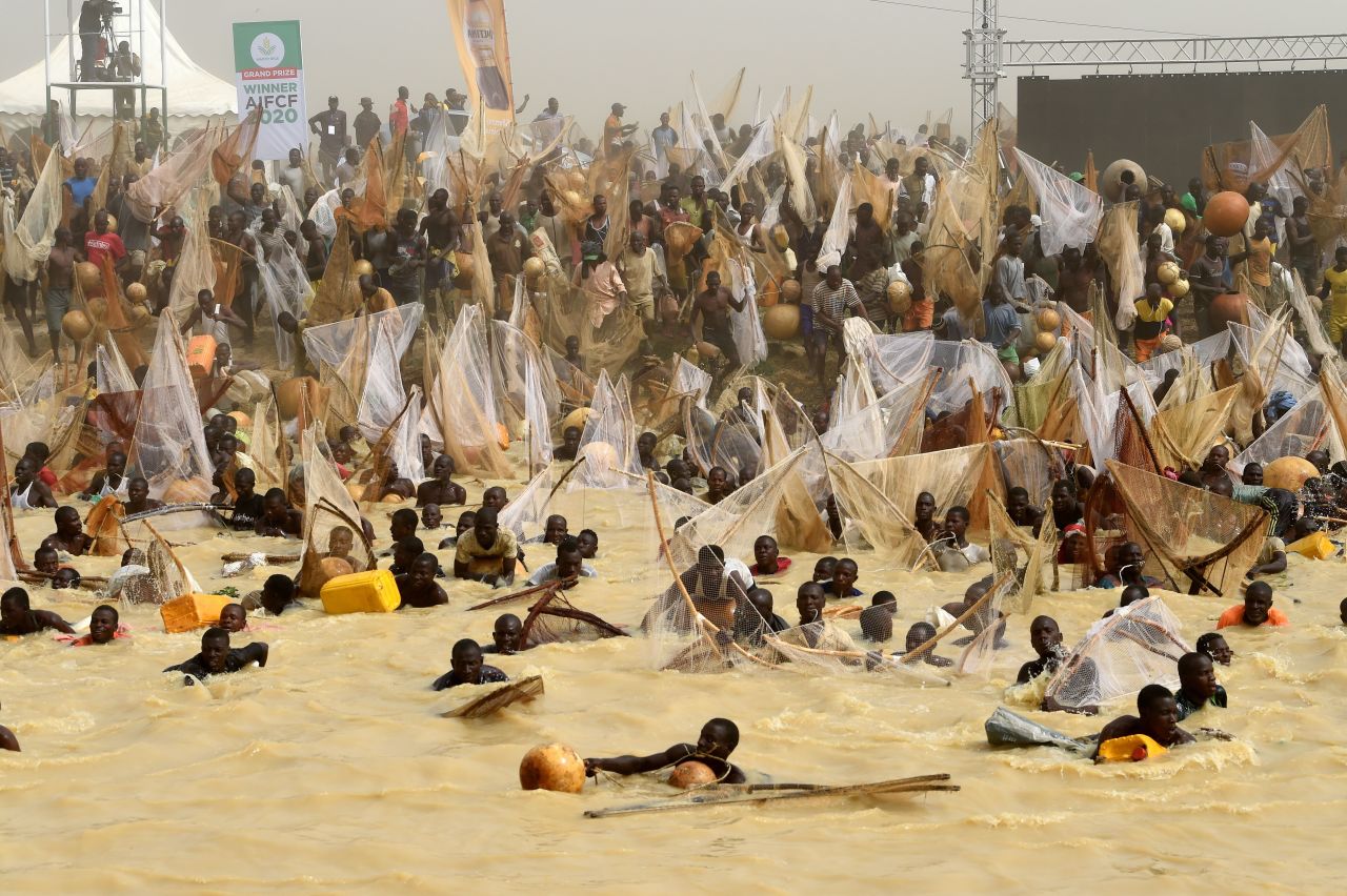 People rush into a river during a fishing festival in Argungu, Nigeria, on Saturday, March 14.