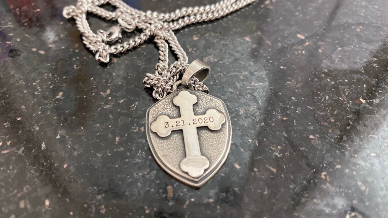 Lindsey Henry and her fiance created a cross necklace with the date 3/21/20 engraved on it. Now, the wedding ceremony is canceled.
