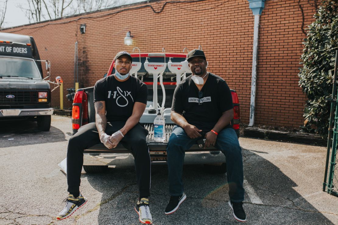 Hip hop artist Lecrae (left) and Love Beyond Walls founder Terence Lester (right) distribute portable wash stations around Atlanta.