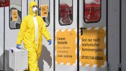 A staff member of the corona test center at the hospital facilities Ludwigsburg carries a transport container for tests on the coronavirus SARS-CoV-2 , which can cause COVID-19, in Ludwigsburg, southern Germany, on March 14, 2020. (Photo by THOMAS KIENZLE / AFP) (Photo by THOMAS KIENZLE/AFP via Getty Images)