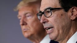 WASHINGTON, DC - MARCH 17: Treasury Secretary Steven Mnuchin (R) speaks while flanked by U.S. President Donald Trump during a briefing about the coronavirus in the press briefing room at the White House on March 17, 2020 in Washington, DC. The Trump administration is considering an $850 billion stimulus package to counter the economic fallout as the coronavirus spreads. (Photo by Drew Angerer/Getty Images)