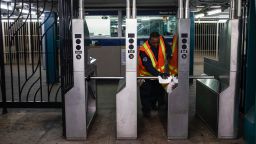 An MTA employee sanitizes surfaces at the CLasson Ave. and Lafayette Ave. subway station with bleach solutions due to COVID-19 concerns, Friday, March 20, 2020, in the Brooklyn Borough in New York. New York Gov. Andrew Cuomo is ordering all workers in non-essential businesses to stay home and banning gatherings statewide. "Only essential businesses can have workers commuting to the job or on the job," Cuomo said of an executive order he will sign Friday. Nonessential gatherings of individuals of any size or for any reason are canceled or postponed. (AP Photo/John Minchillo)