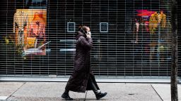 A person wearing a face mark walks past a temporary closed business in Philadelphia, Thursday, March 19, 2020. Pennsylvania reported another big jump in confirmed coronavirus Thursday. The state Department of Health reported that cases topped 180, up 40%.