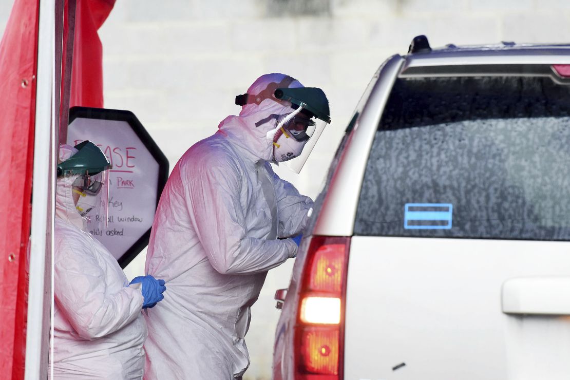 West Virginia now has drive-through sites for coronavirus testing as here, in Oak Hill, where clinical care providers take swabs from a patient.