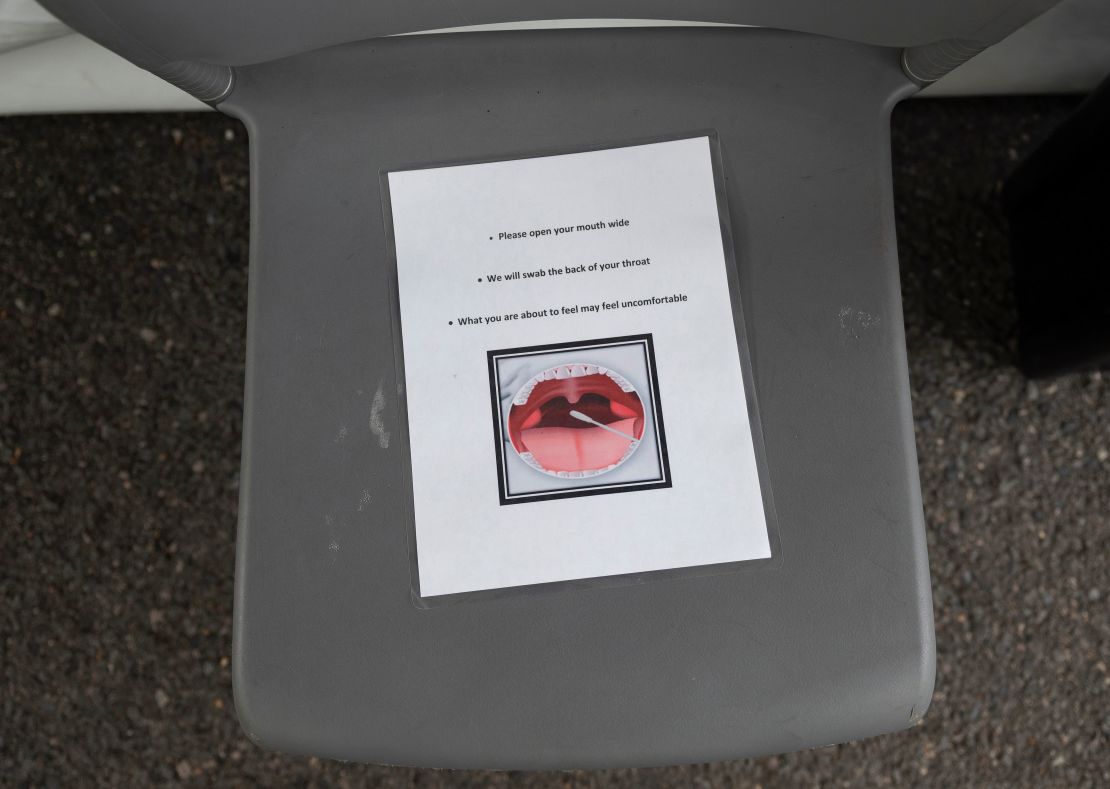 Instructions to be shown to people being tested for coronavirus are seen on a chair at a drive-through testing site in Arlington, Virginia.