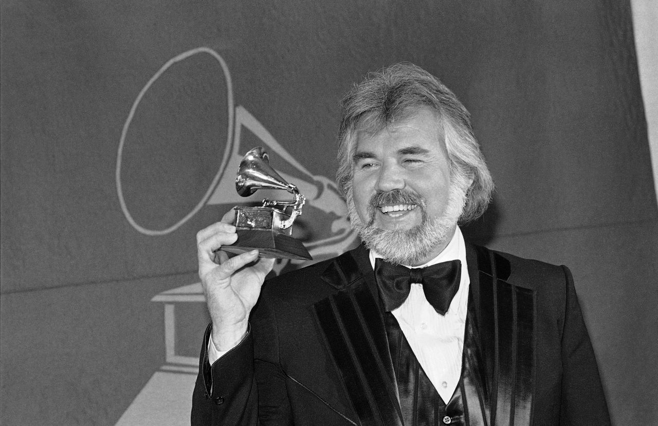 Rogers holds his Grammy award for best male country performer in 1980.