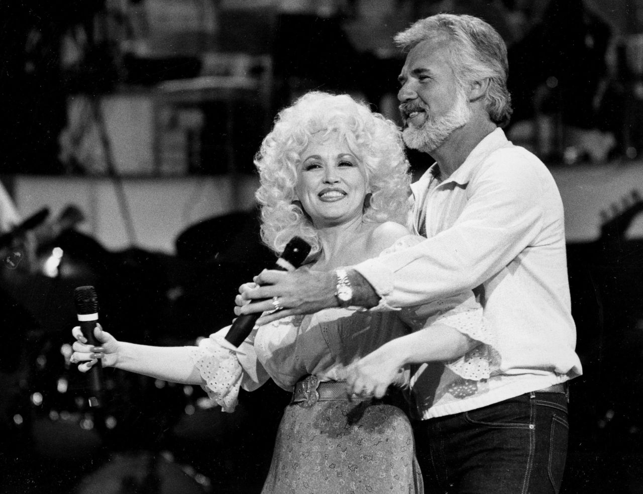 Dolly Parton and Rogers rehearse a song for their appearance on the TV show "Live... And in Person" in 1983.