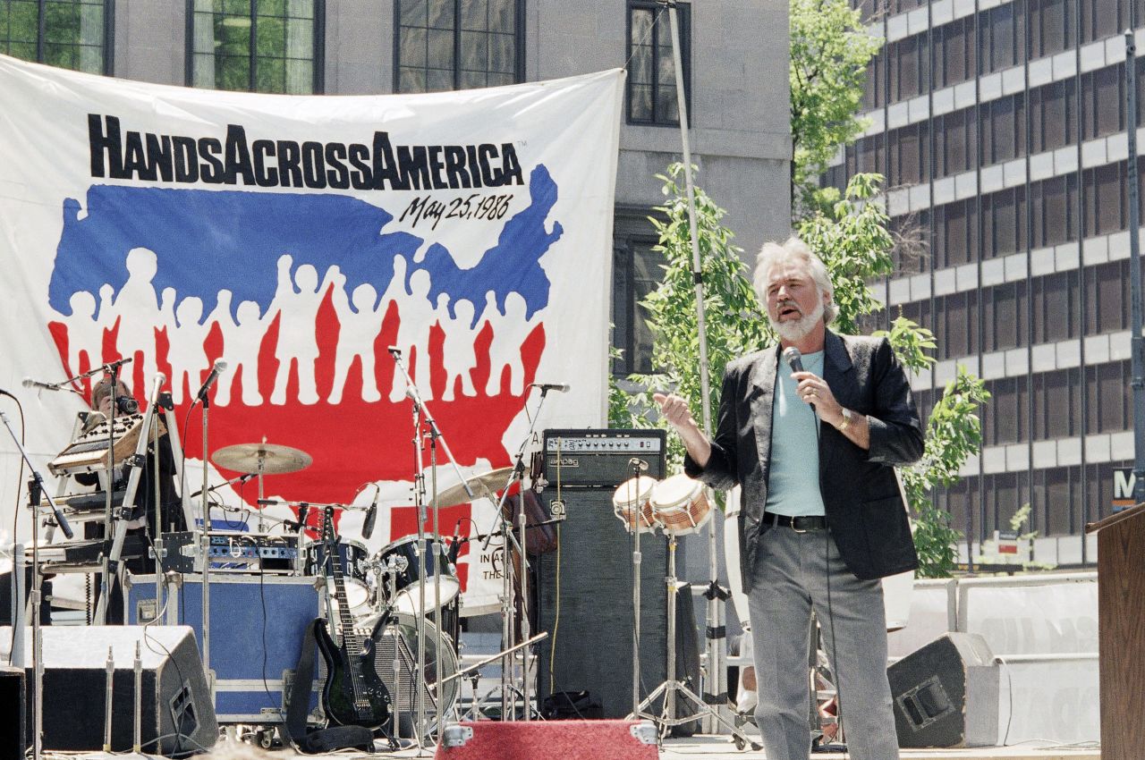 Rogers, national co-chairman of Hands Across America, gestures while addressing a sign up rally for the group in 1986.
