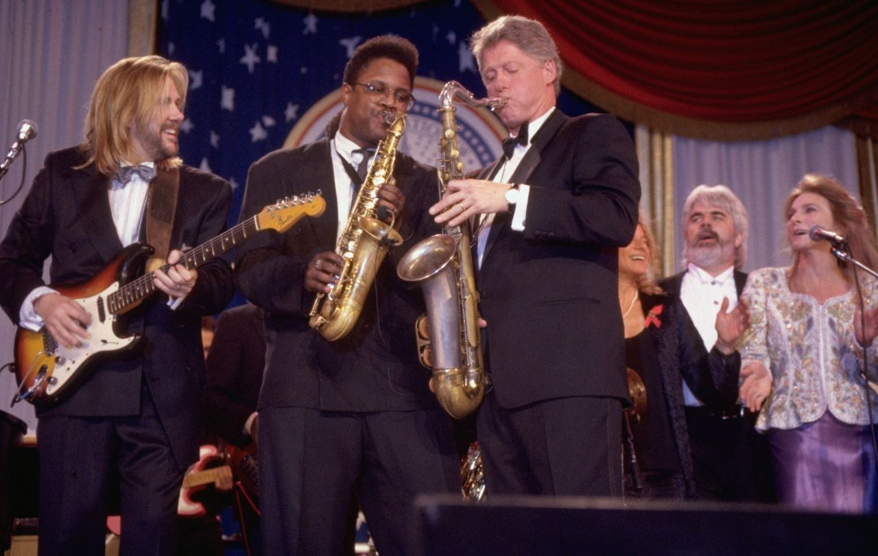 Rogers sings behind President Bill Clinton as they perform at the DC Armory Ball during Clinton's inauguration festivities in 1993.