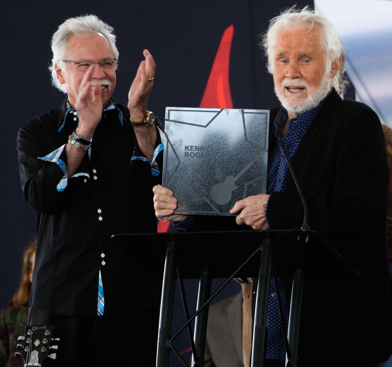 Joe Bonsall and Rogers pose as Rogers is inducted into the Nashville Music City Walk of Fame on in 2017.