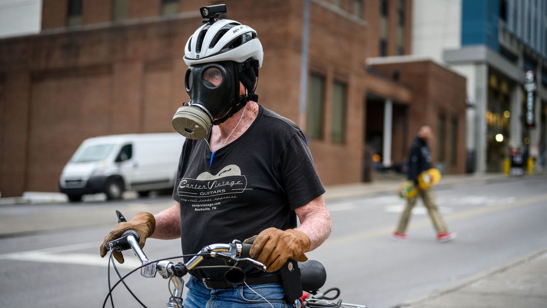 Bert Kencke, 73, of Nashville, heads to Broadway wearing a gas mask Wednesday.