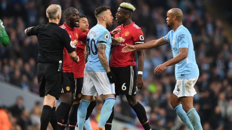 Manchester United and Manchester City players clash during their Premier League match.