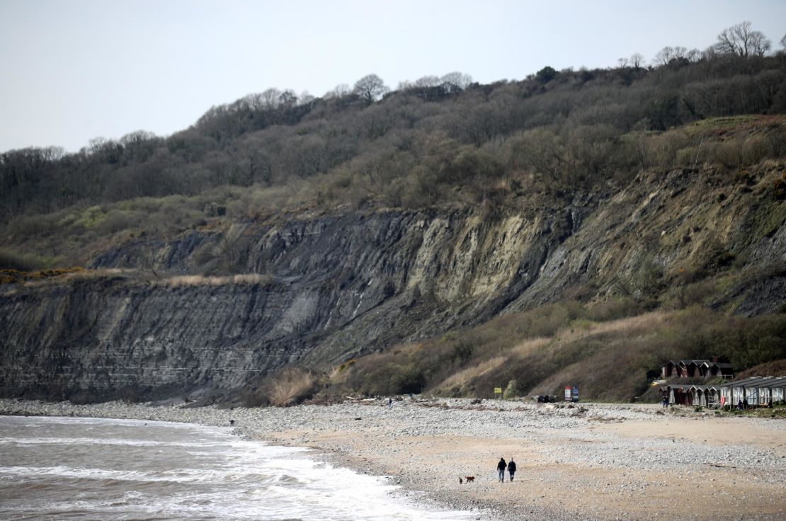 People walk on the beach in Lyme Regis in West Dorset, England, on March 21.