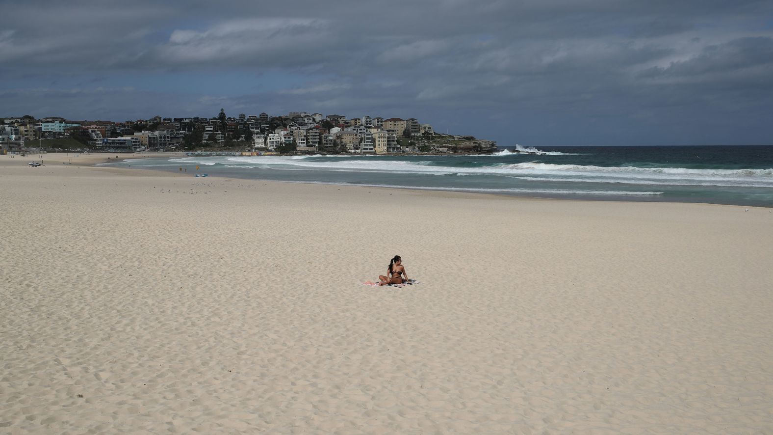 A single sunbather remains following the closure of Sydney's Bondi Beach on March 21.