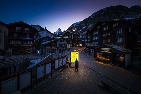 A pedestrian looks at a map at the Zermatt ski resort in Switzerland on March 18.