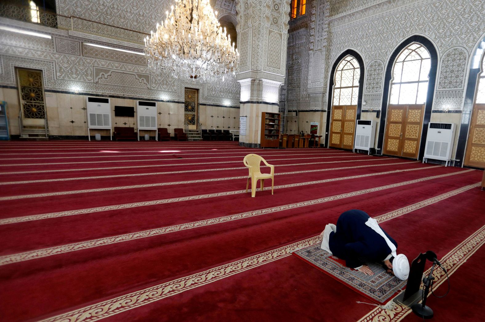 A cleric prays in an empty mosque in Baghdad, Iraq, on March 20.