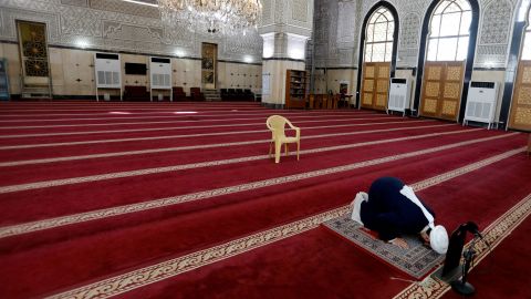 A cleric prays in an empty mosque in Baghdad, Iraq, on March 20.