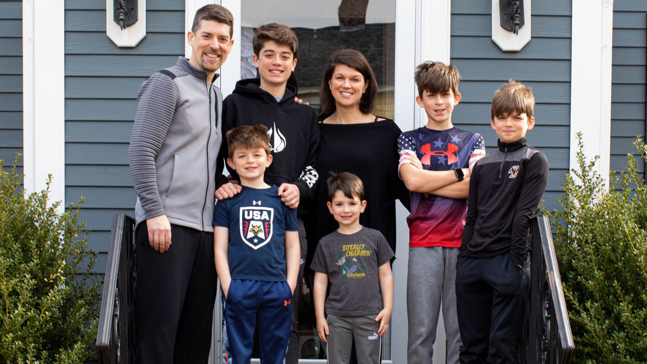 A family with five boys poses in front of their home as a part of The Front Steps Project.