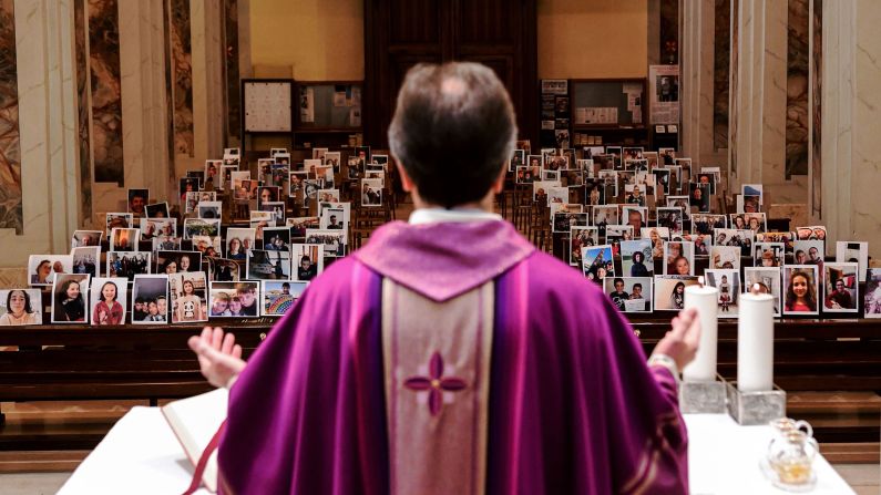 Giuseppe Corbari holds Sunday Mass in front of photographs sent in by his congregation members in Giussano, Italy. Many religious services are being streamed online so that people can worship while still maintaining their distance from others.