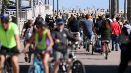 People ride their bikes along a bike bath near the pier on March 21, 2020 in Huntington Beach, California. California Governor Gavin Newsom issued a statewide 'stay at home' order for California's 40 million residents except for 'necessary activities' in the hopes of slowing the spread of coronavirus (COVID-19). 