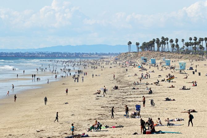 People are seen on California's Huntington Beach on March 21, 2020. Crowds descended on California beaches, hiking trails and parks over the weekend <a href="https://www.cnn.com/2020/03/23/us/california-stay-at-home-beach-goers/index.html" target="_blank">in open defiance of a state order</a> to shelter in place and avoid close contact with others.