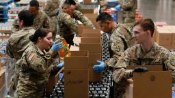 Members of 115th Regional Support Group of the California National Guard load boxes with food at the Sacramento Food Bank and Family Services in Sacramento, Calif., Saturday, March 21, 2020. Food banks have been hit hard by a shortage of volunteers due to the mandatory stay-at-home order caused by the coronavirus.