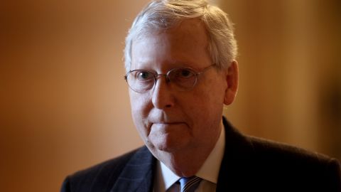 Senate Majority Leader Mitch McConnell (L) (R-KY) walks to his office while arriving at the U.S. Capitol on March 18, 2020.