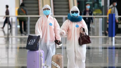 Arrivals at Hong Kong airport on March 18 seen wearing heavy protective gear against the novel coronavirus.