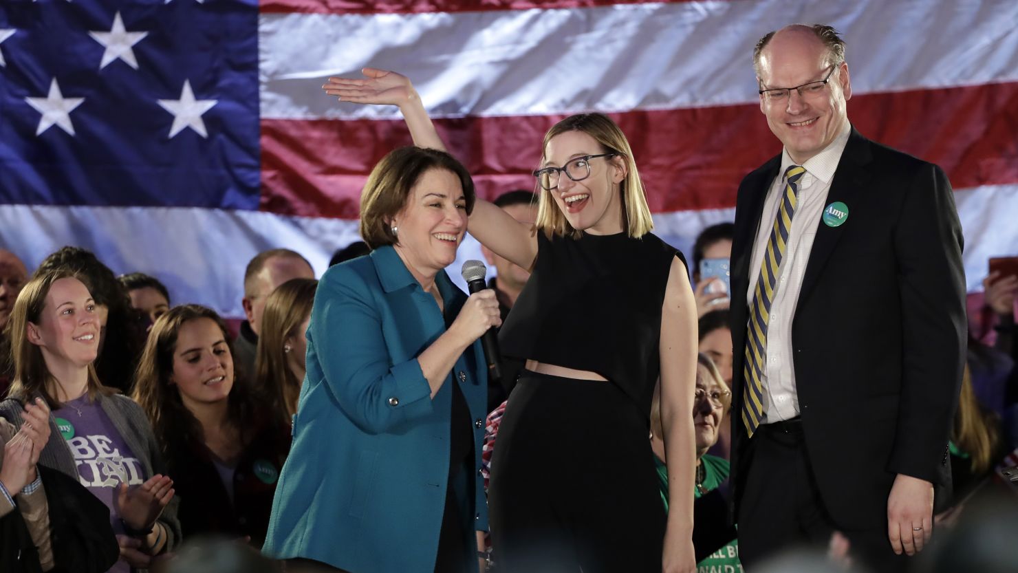 Sen. Amy Klobuchar, a Minnesota Democrat who was also then a presidential candidate, at left, introduces her daughter Abigail, center, and husband John Bessler during a rally at Franklin Junior High School in Des Moines, Iowa, in February.
