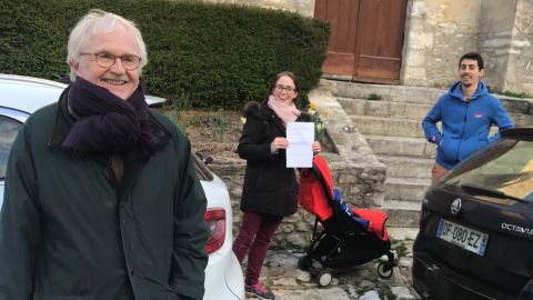 Neighbors Alain de Gourdon and his family out for a walk while social distancing. De Gourdon's daughter holds up the paperwork needed.
