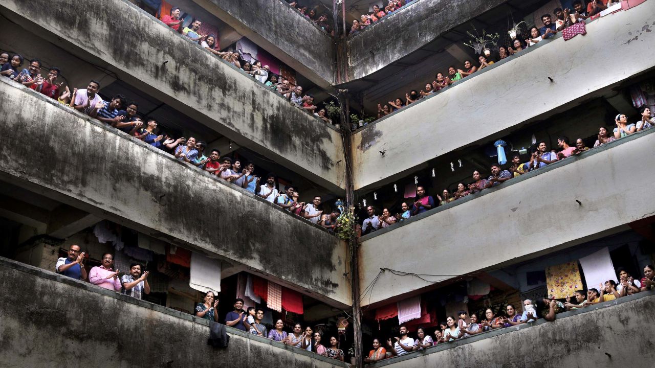 People clap from balconies in show of appreciation to health care workers in Mumbai, India on March 22, 2020.