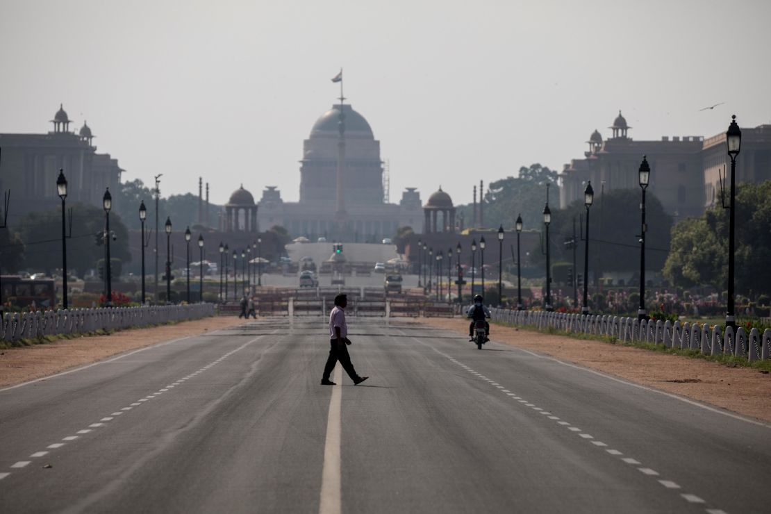 A man crosses a deserted Rajpath in New Delhi on March 22, 2020. 