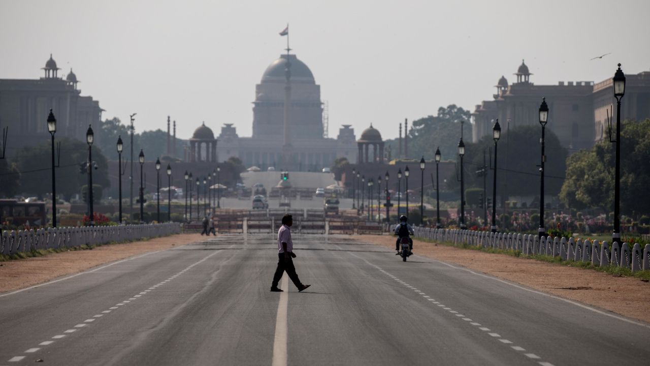 A man crosses a deserted Rajpath in New Delhi on March 22, 2020. 