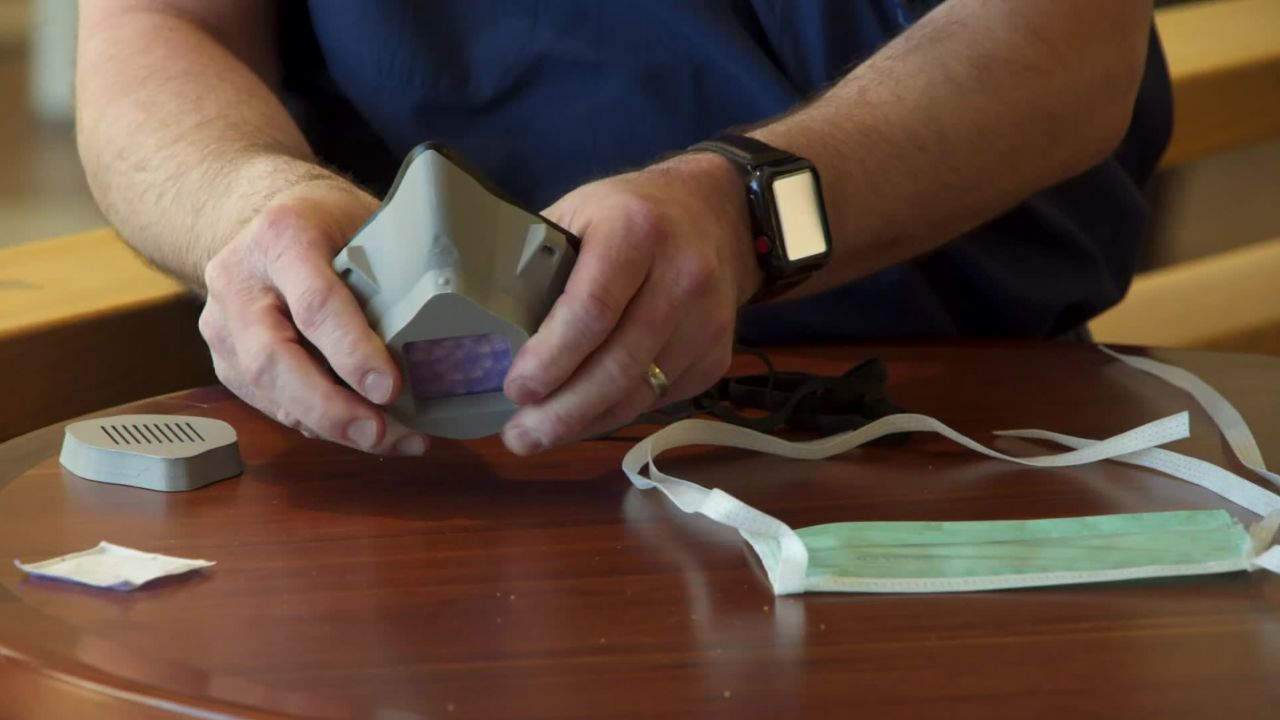 The plastic mask uses a small square of a surgical mask as a filter.