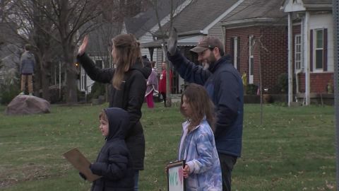 Students and parents came outside to say hello to teachers from a safe distance.