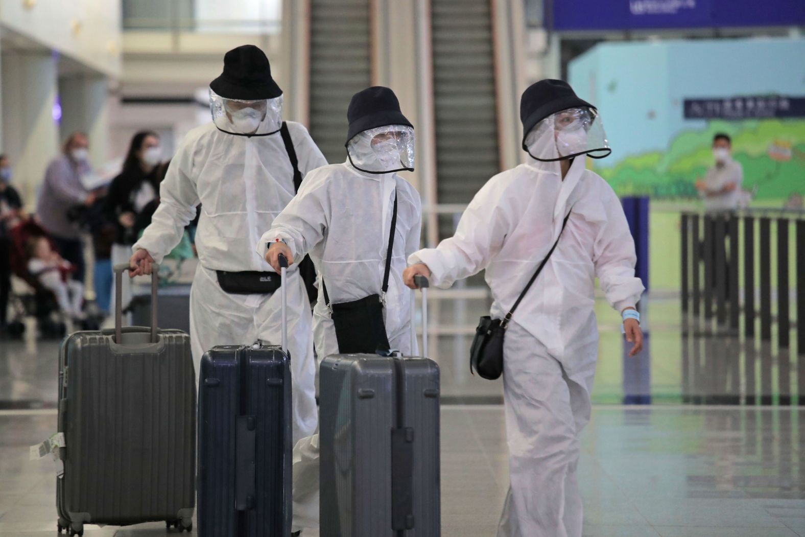 Passengers arrive at Hong Kong International Airport on March 23, 2020.