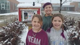 Shelly Anderson's kids, Claire (7) Caleb (11) and Emma (8, on the left) help keep their Little Free Pantry stocked. 
