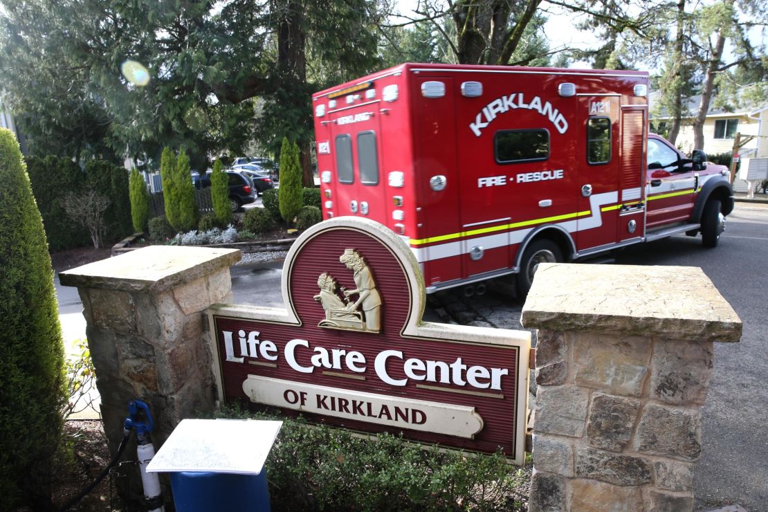 An ambulance leaves the Life Care Center in Kirkland, Washington. 