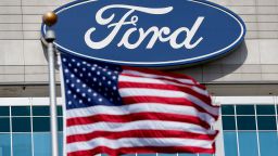A U.S. flag flies at the Ford Motor Co. headquarters in Dearborn, Michigan, U.S., on Wednesday, March 18, 2015. Ford, the second largest U.S. automaker, is making a big investment in Russia by introducing six new models from the middle of last year to the end of this year. Photographer: Jeff Kowalsky/Bloomberg via Getty Images