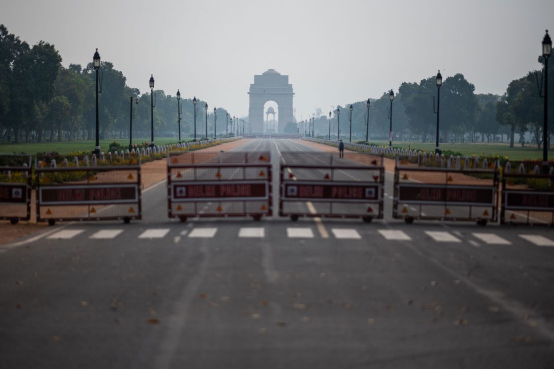 A man walks on a deserted path leading to India Gate during a government-imposed lockdown in New Delhi on March 24, 2020.
