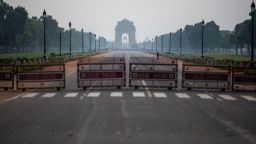 A man walks on a deserted Rajpath leading to India Gate during a government-imposed lockdown as a preventive measure against the COVID-19 coronavirus in New Delhi on March 24, 2020.