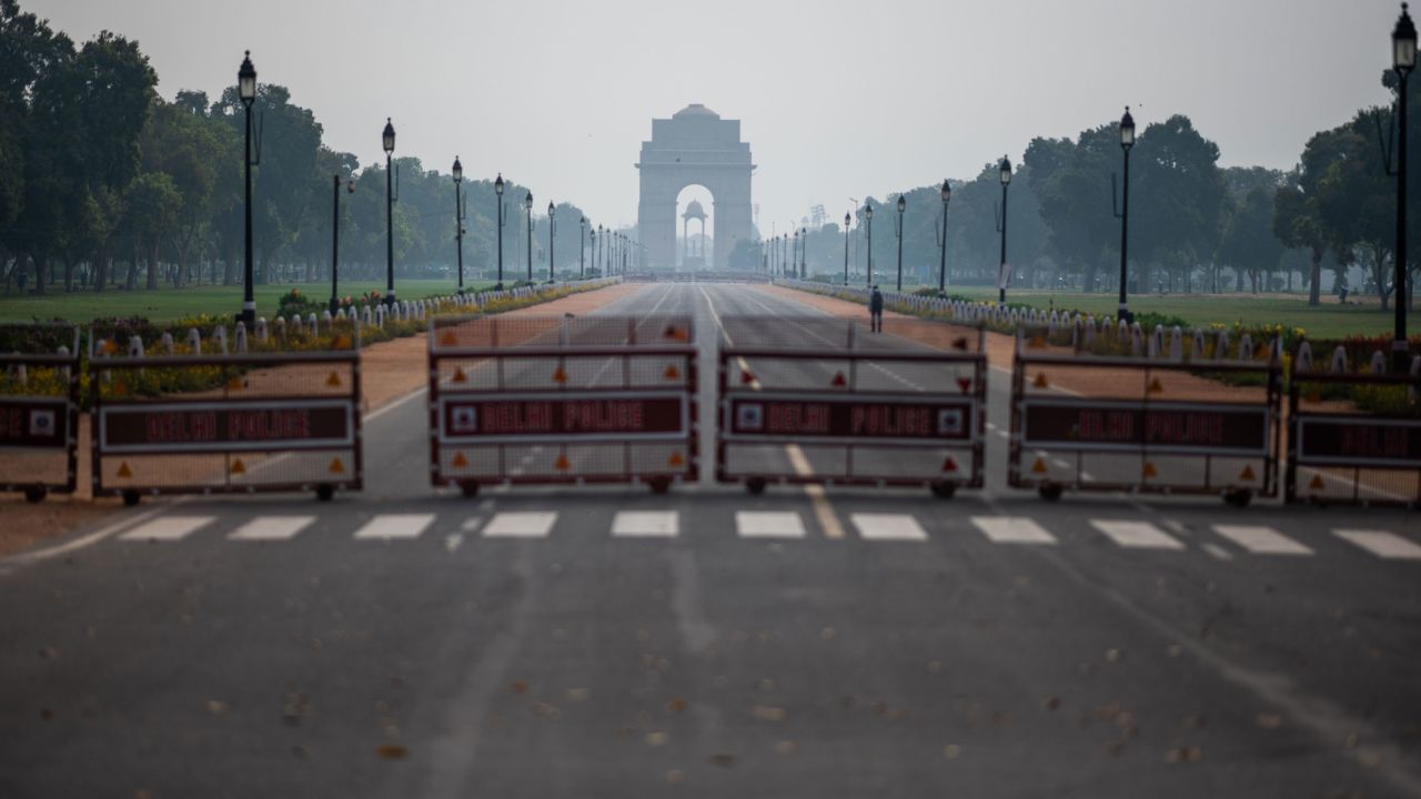 A man walks on a deserted path leading to India Gate during a government-imposed lockdown in New Delhi on March 24, 2020.