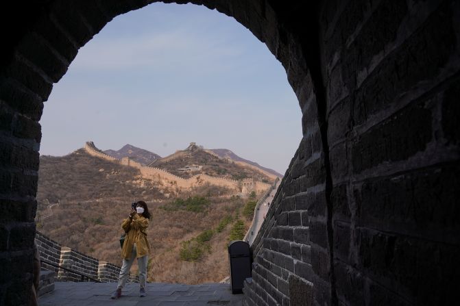 A tourist wears a face mask while visiting the Badaling section of the Great Wall of China on March 24, 2020. The section <a href="index.php?page=&url=https%3A%2F%2Fwww.cnn.com%2Ftravel%2Farticle%2Fbadaling-great-wall-china-reopens-intl-hnk%2Findex.html" target="_blank">reopened</a> to visitors after being closed for two months.
