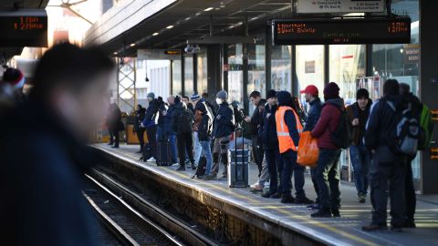 Passengers wait on the platform for a Central Line underground train in London.