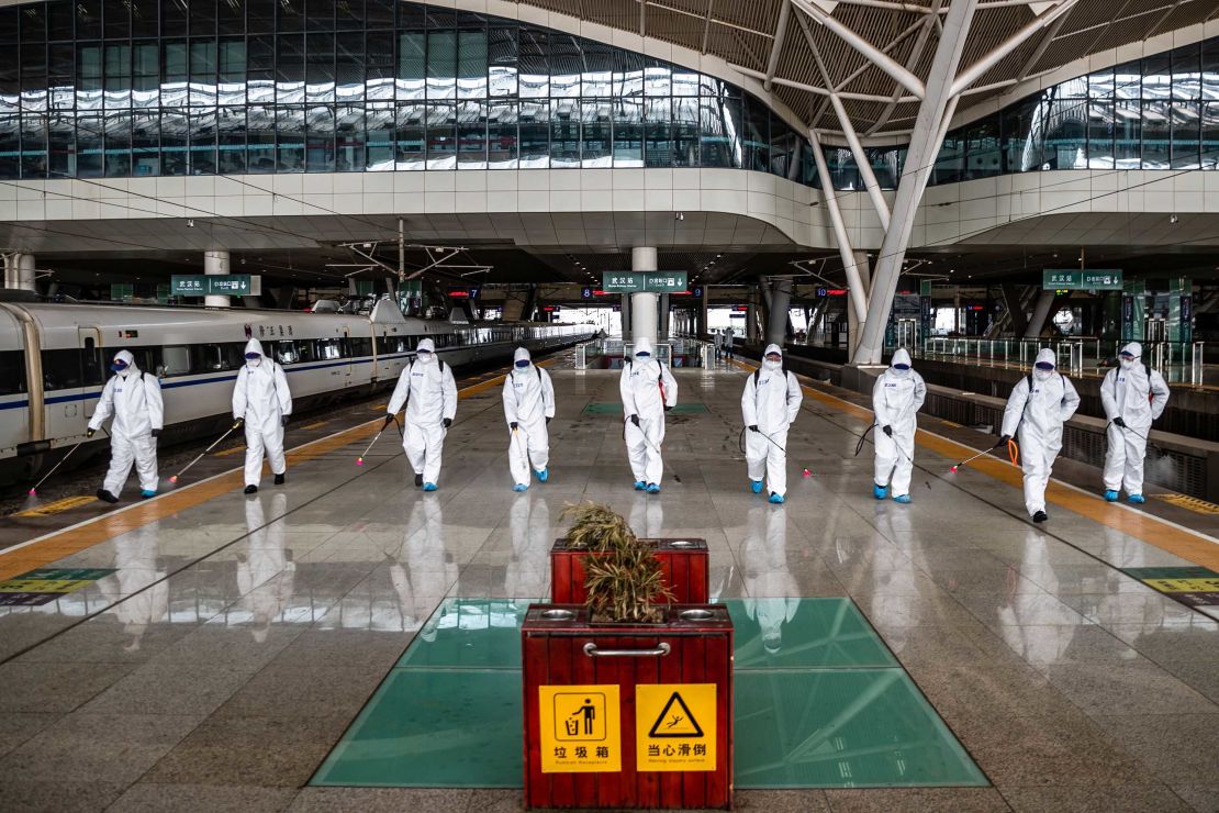 Staff members spray disinfectant at the Wuhan Railway Station on March 24.