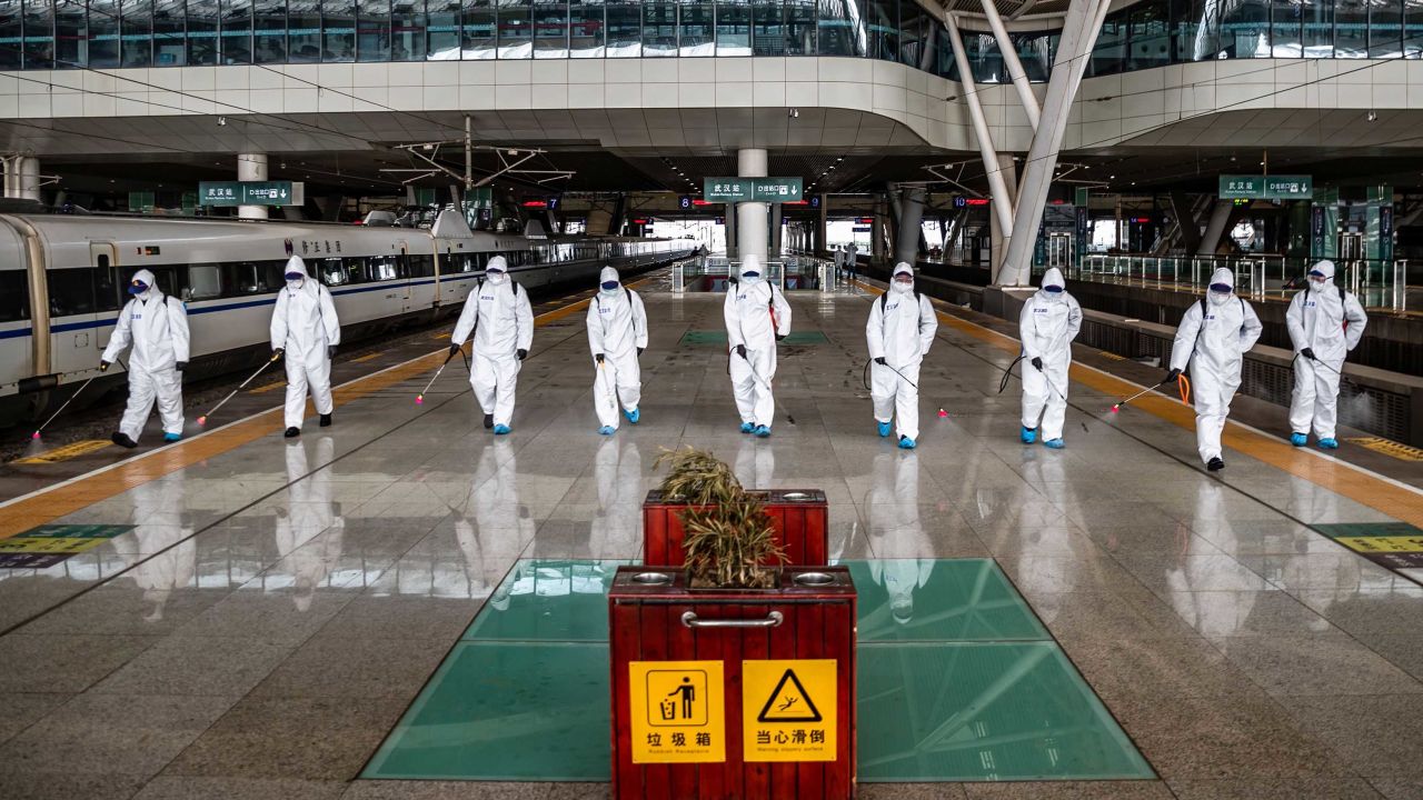 Staff members spray disinfectant at the Wuhan Railway Station on March 24.