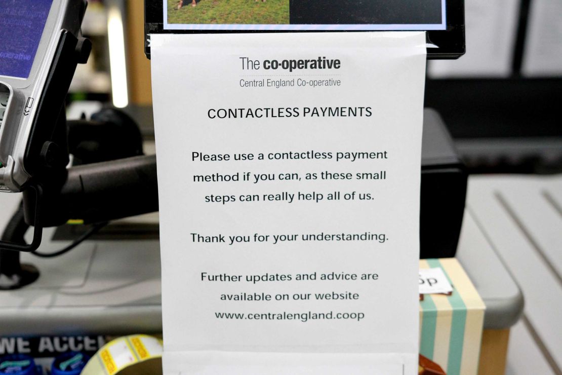 A sign urging customers to use 'contactless payments' at a Co-Operative Store amid Coronavirus fears in Derby, United Kingdom.