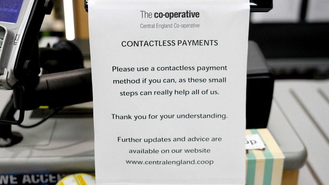 A sign urging customers to use 'contactless payments' at a Co-Operative Store amid Coronavirus fears in Derby, United Kingdom.