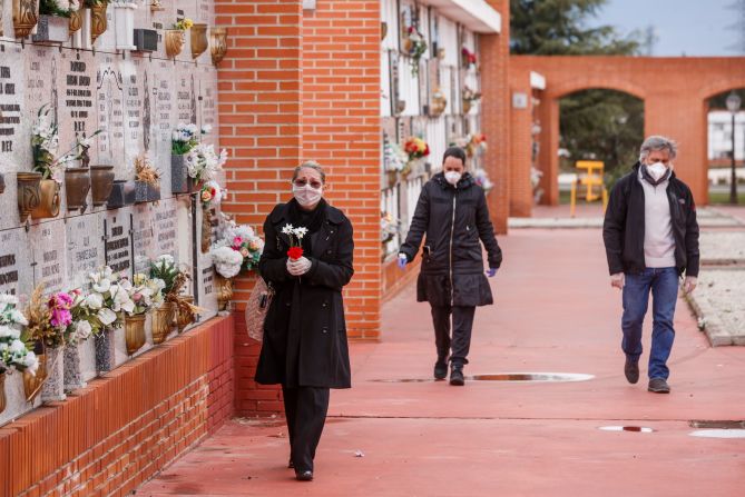 People arrive at the South Municipal Cemetery in Madrid to attend the burial of a man who died from the coronavirus.