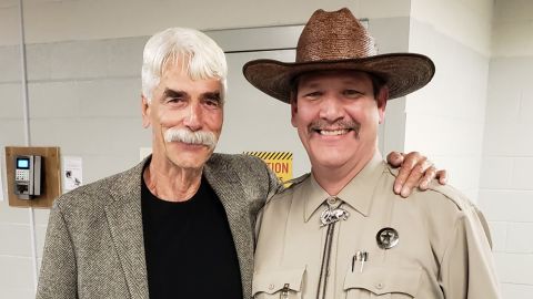 Tim, right, has become an internet favorite after he was put in charge of a museum's social media accounts. He is photographed here with actor Sam Elliot and Elliot's "quality mustache."